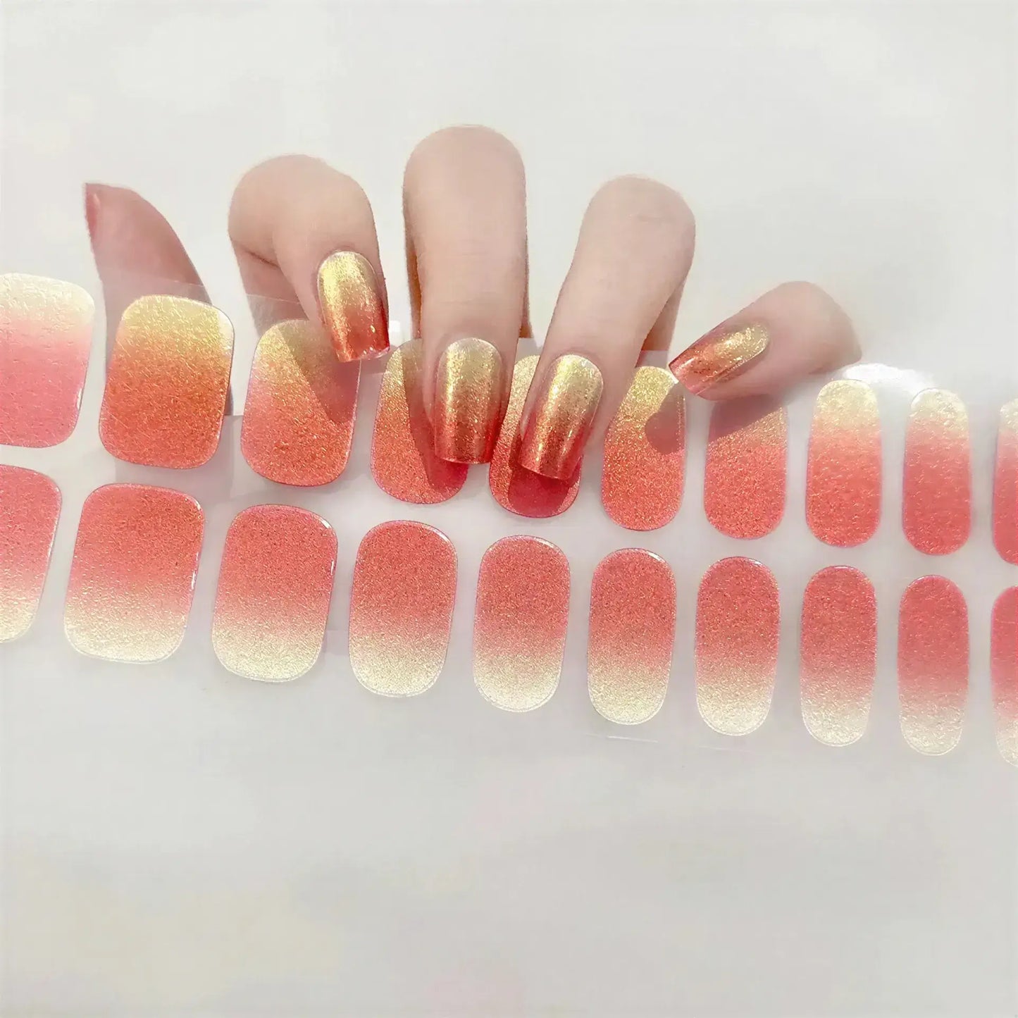 Currant starter kit featuring gradient orange and gold nail wraps displayed on a hand with manicured nails.