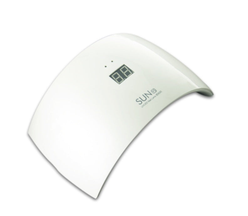 White UV LED lamp with a curved design and digital display for nail drying.