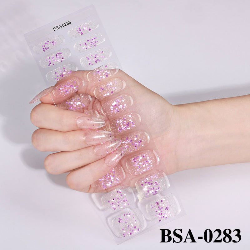 Pastel Non-UV press-on nails with glitter, featuring a hand holding a clear display sheet of various nail designs.