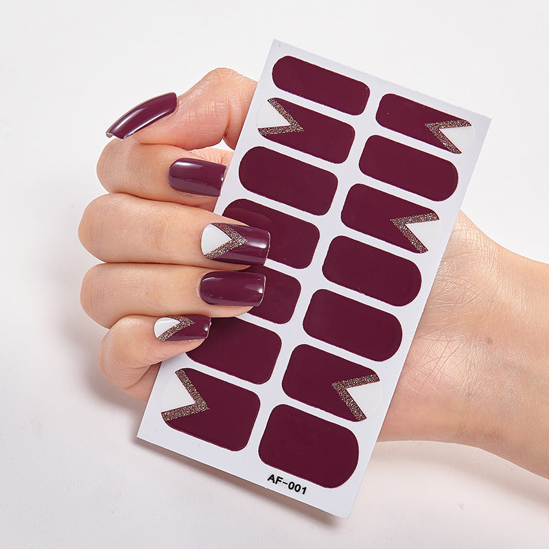 Every Shade of You nail wraps featuring deep burgundy and silver accents, held in a hand against a white background.