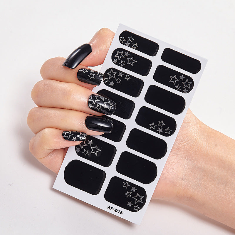 Every Shade of You nail art set featuring black and silver star designs on a nail sticker sheet held in a hand.