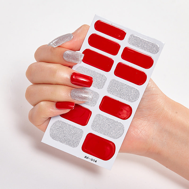 Red and silver nail stickers displayed on a hand with long nails, featuring various designs and shapes.