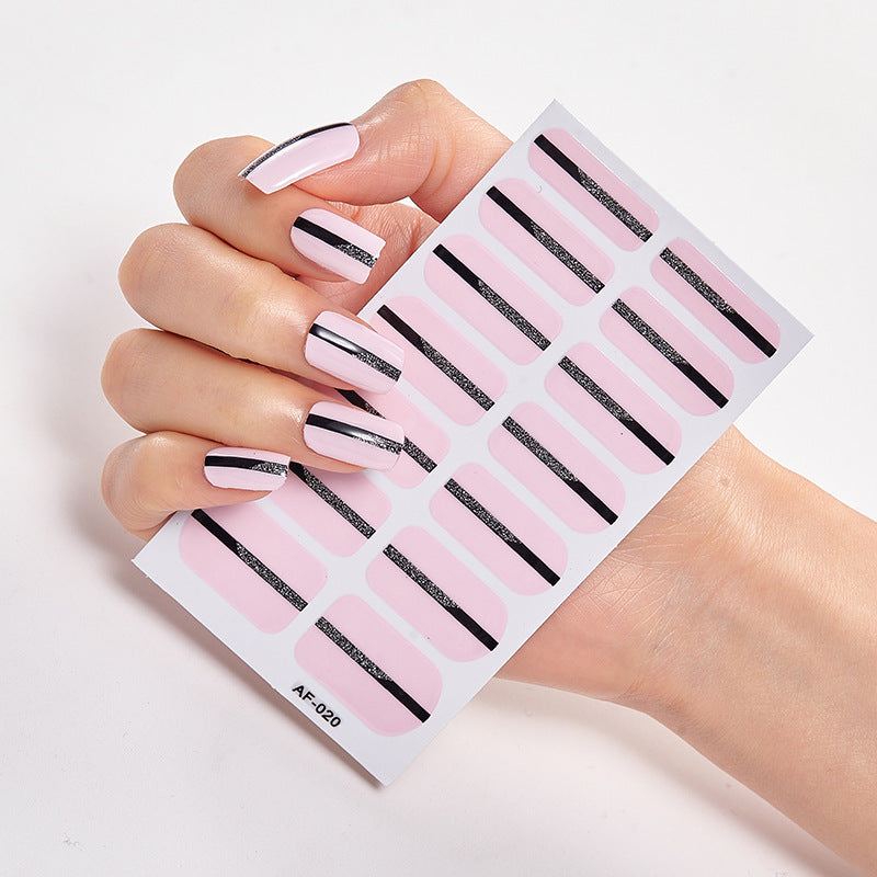 Every Shade of You nail wraps featuring a glossy pink finish with black stripe designs on a hand holding the product sheet.