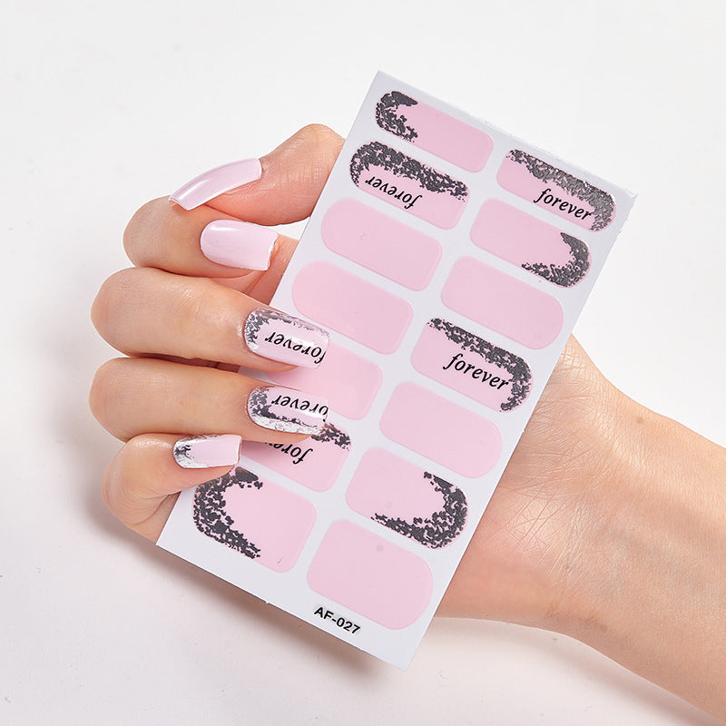 Nail art stickers featuring pink and black designs with the words "forever" and "joyever" on a hand with manicured nails.