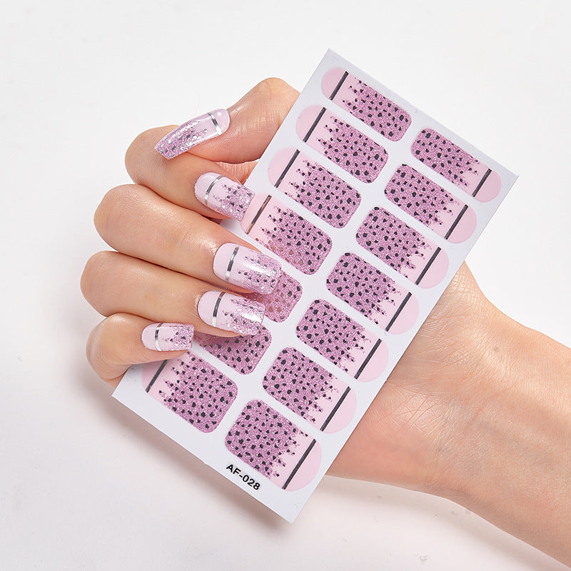 Every Shade of You nail wraps displayed on a hand, featuring pink designs with glitter and black accents.