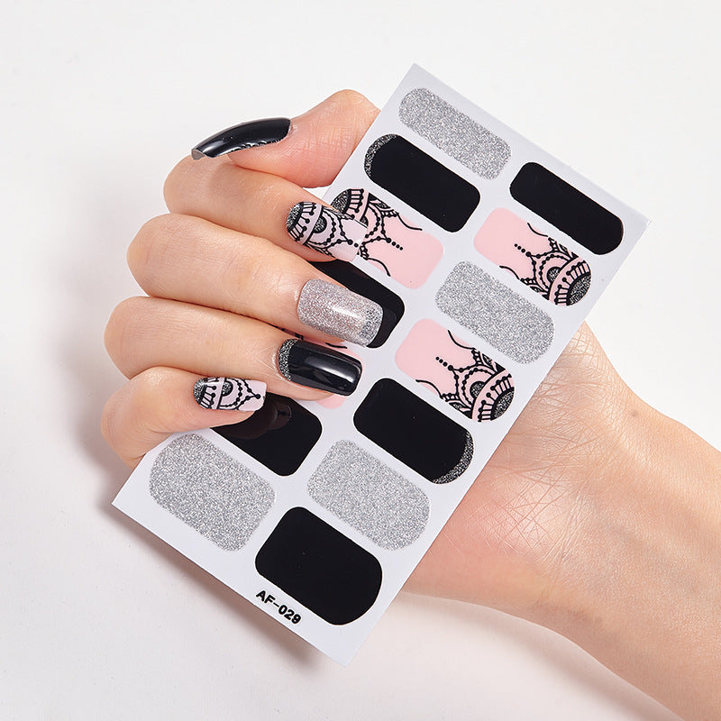 Every Shade of You nail art set featuring various designs, including black, pink, and silver patterns on a hand.
