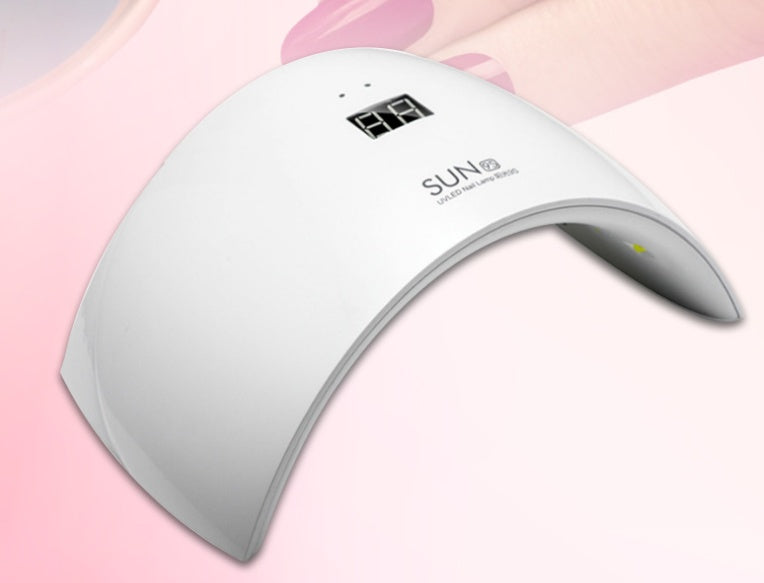 White UV LED lamp with a digital display, curved design, and yellow light indicator on a pink background.
