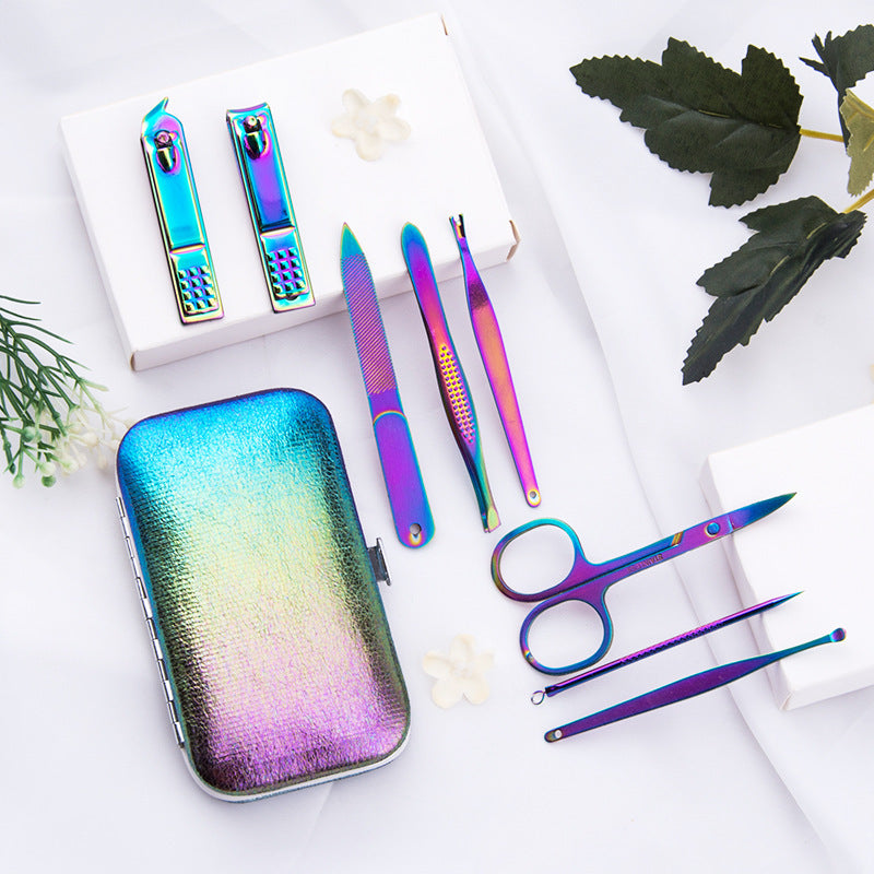 8-piece manicure set featuring a holographic case, nail clippers, scissors, tweezers, and cuticle tools arranged on a surf...