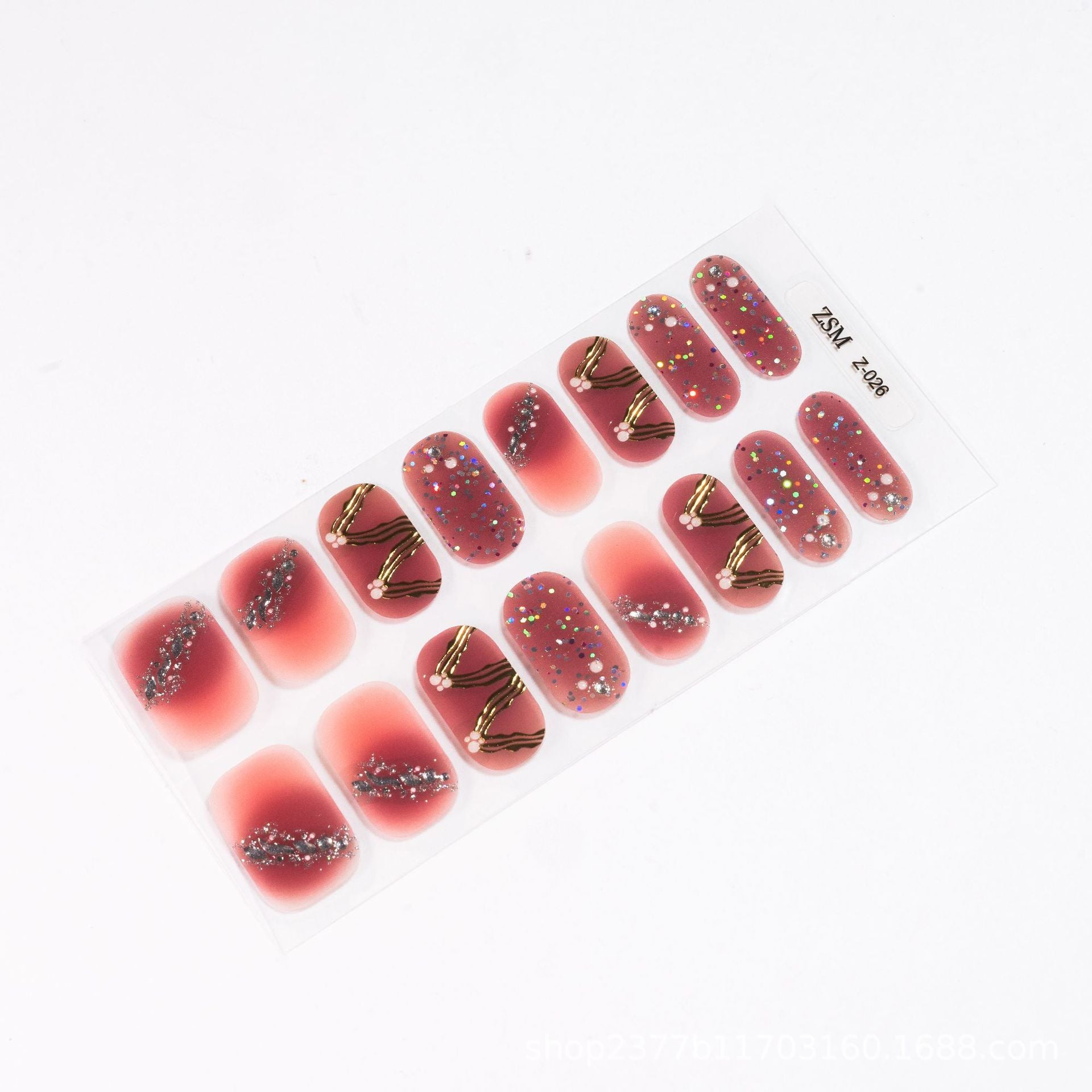 3D nail stickers featuring a gradient pink design with gold accents and glitter embellishments on a clear backing.