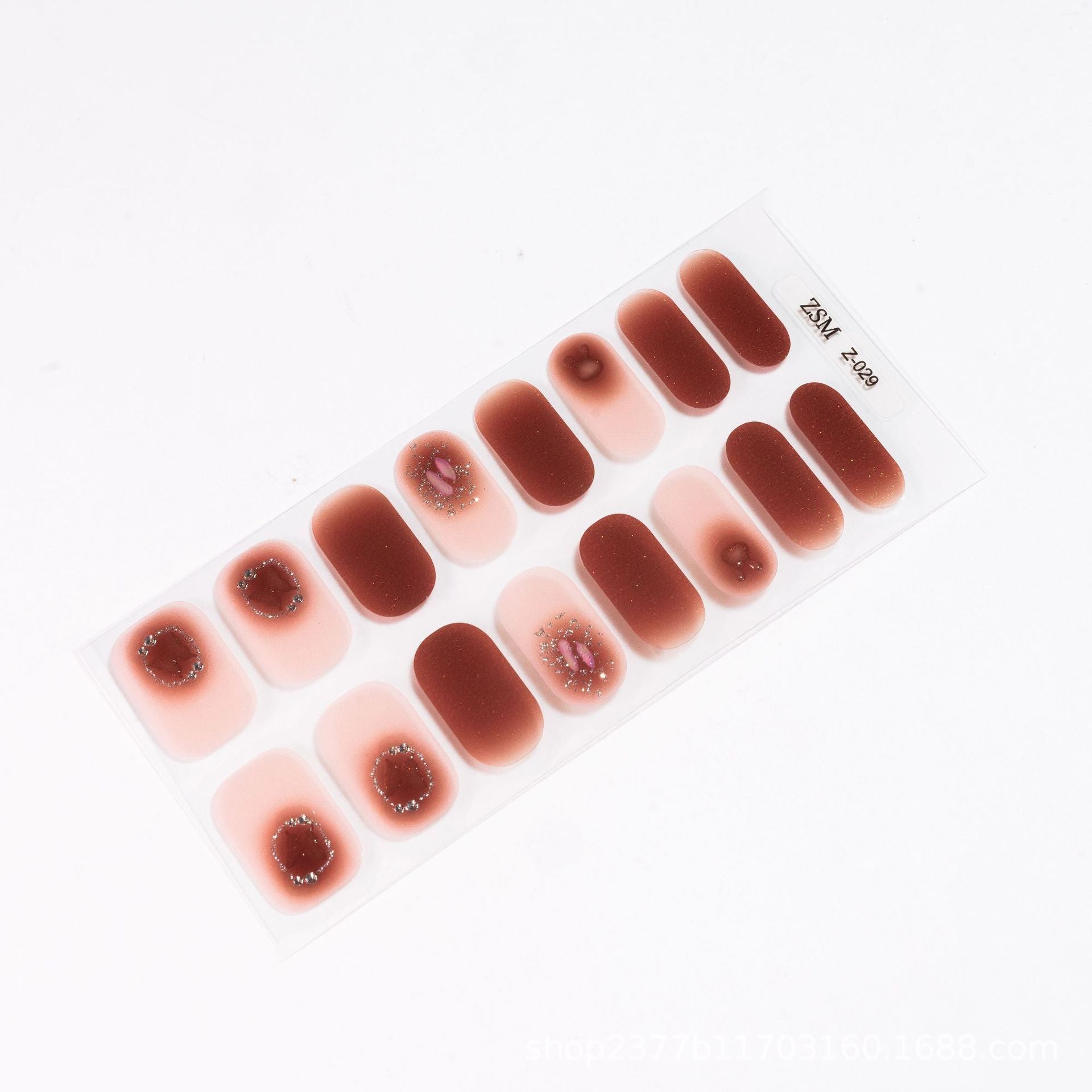 3D nail sticker sheet featuring various designs in shades of pink and brown with embellishments.