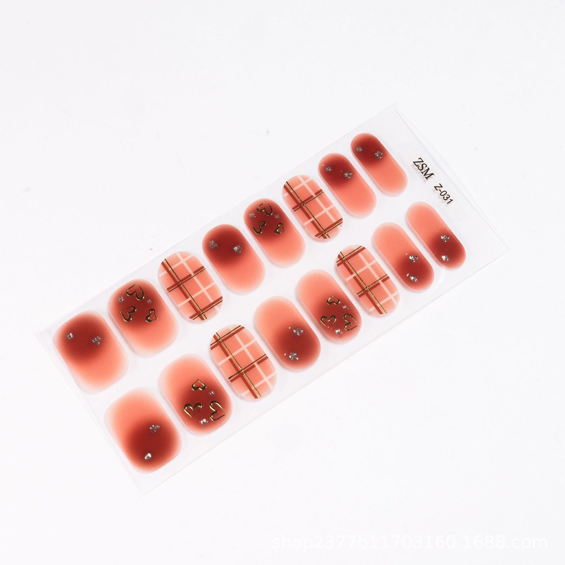 3D nail sticker sheet featuring various designs in red and beige with plaid patterns and embellishments.