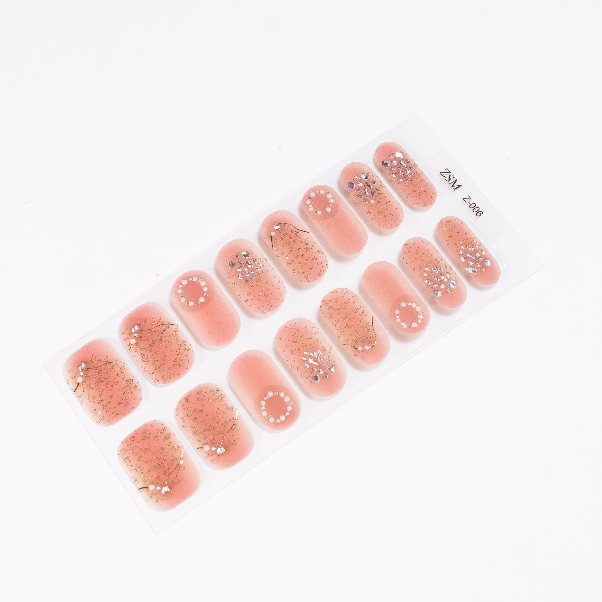 3D nail sticker set featuring various designs with pink and gold accents on a clear backing.