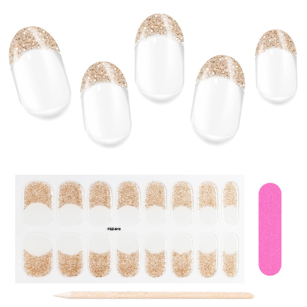 French Glitter press-on nails with clear tips and gold glitter accents, including a nail file and wooden stick.