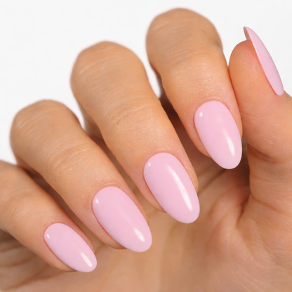 Currant™ nail wraps displayed on a hand with long, oval-shaped nails in a soft pink color.