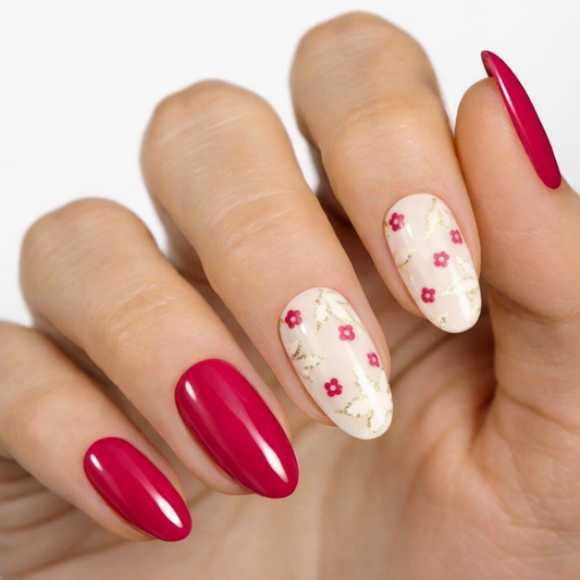 Currant™ starter kit featuring red and floral nail wraps on a hand with manicured nails.