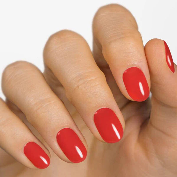 Currant™ nail wraps in a glossy red shade applied on natural nails, showcasing a hand with well-groomed fingers.