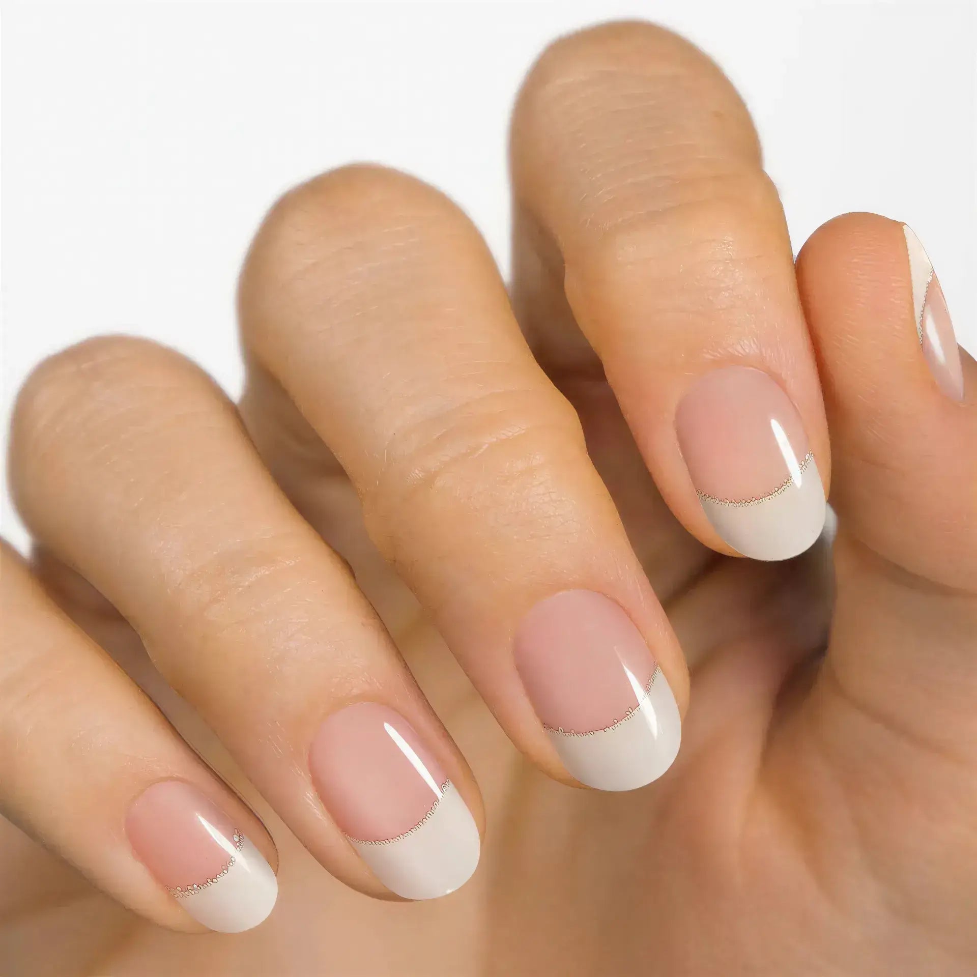 Currant™ Starter Kit features nude nails with white tips and a glitter line on well-groomed hands.