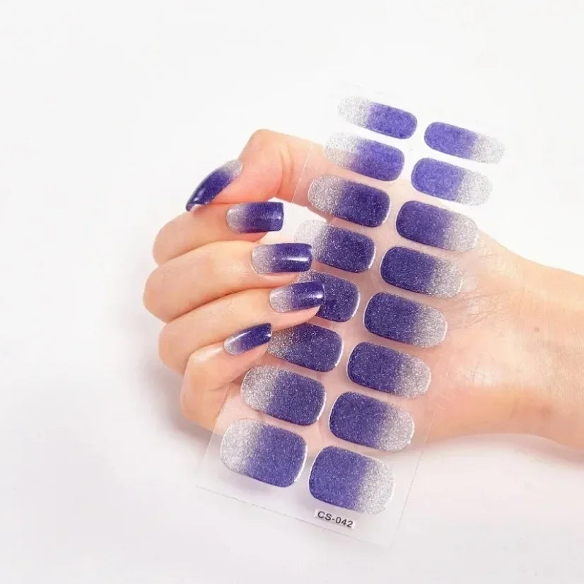Currant™ Fade press-on nails in a gradient of purple shades, displayed on a hand with long, pointed nails.