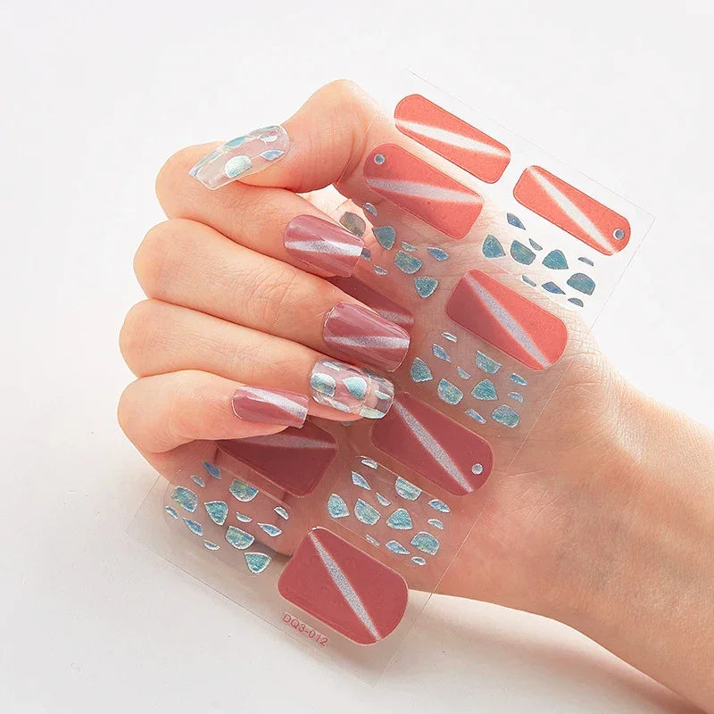 Currant™ Marble nail art set featuring red and blue designs on a clear backing, held in a hand.