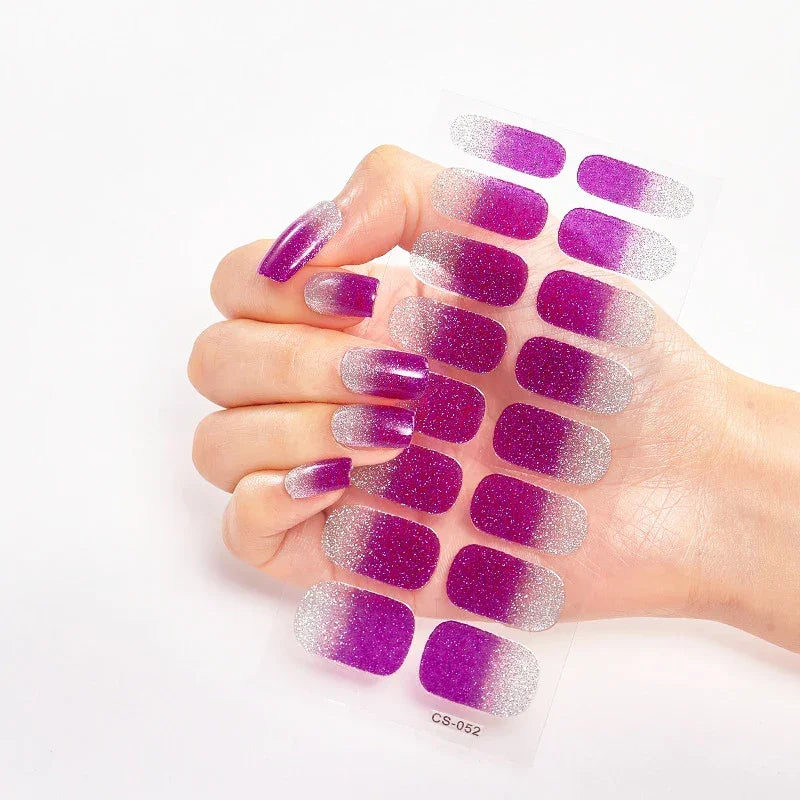 Currant™ Fade nail wraps featuring a gradient of purple to silver on a clear backing, held by a hand.