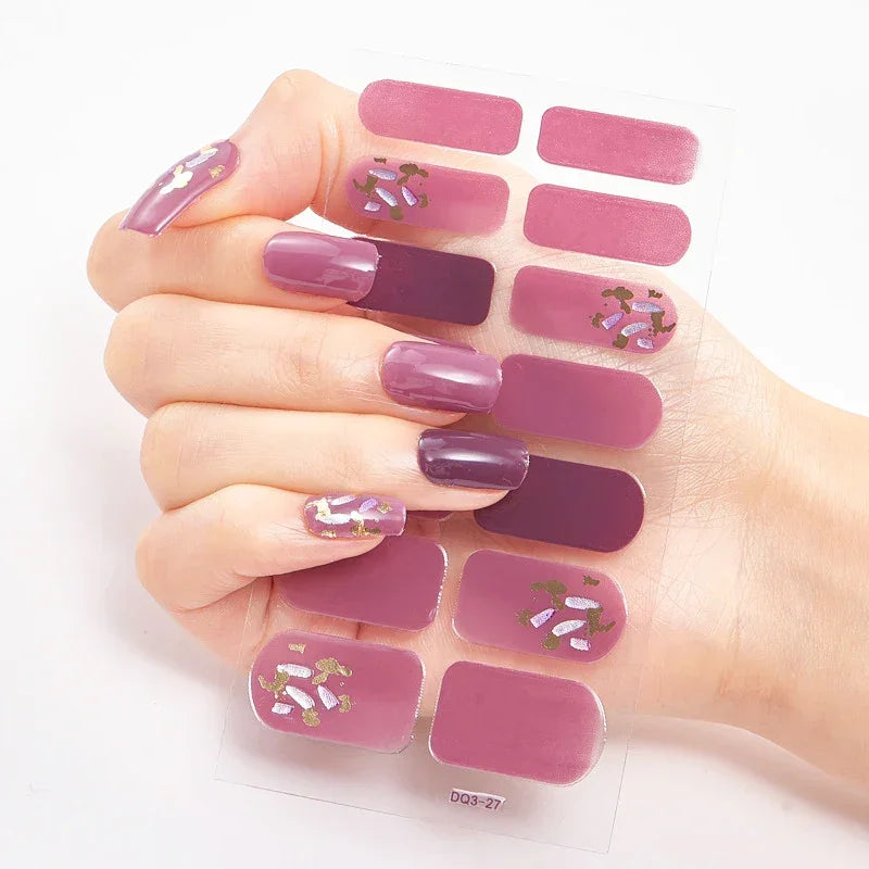 Currant™ Marble nail wraps featuring various shades of purple and floral designs on a hand with manicured nails.