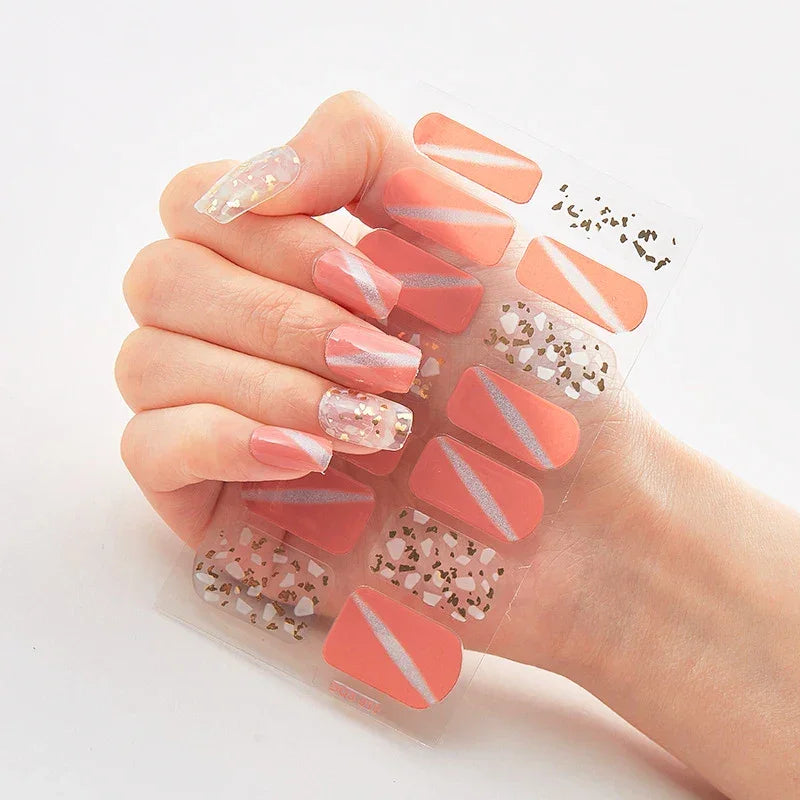 Currant™ Marble nail wraps featuring pink and clear designs with glitter and gold accents on a hand display.