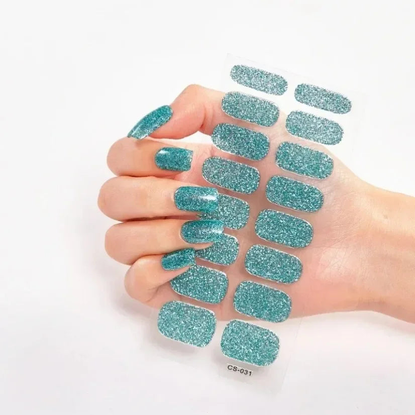 Currant™ Star teal glitter nail wraps displayed on a hand with long, manicured nails.