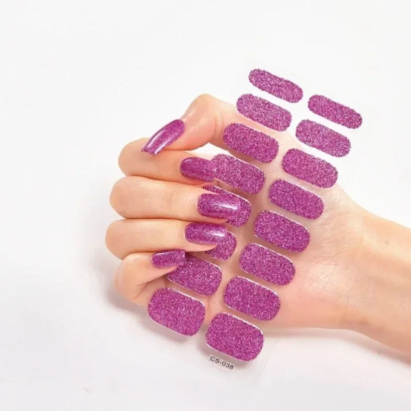 Currant™ Star nail wraps in vibrant purple glitter, displayed on a hand with long nails.