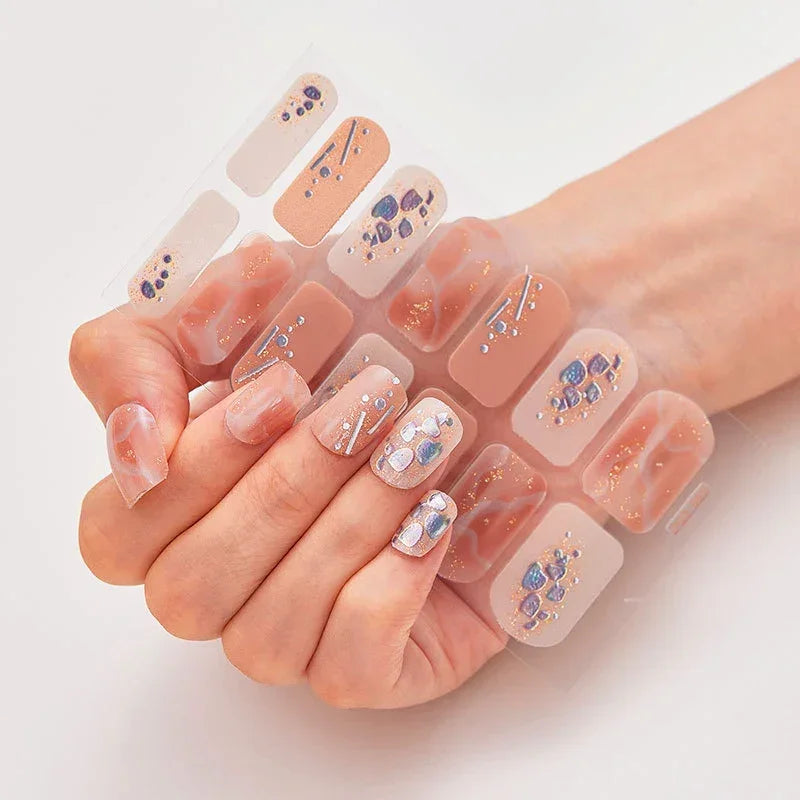 Currant™ Marble nail wraps featuring a nude base with blue and silver accents, held in a hand against a light background.