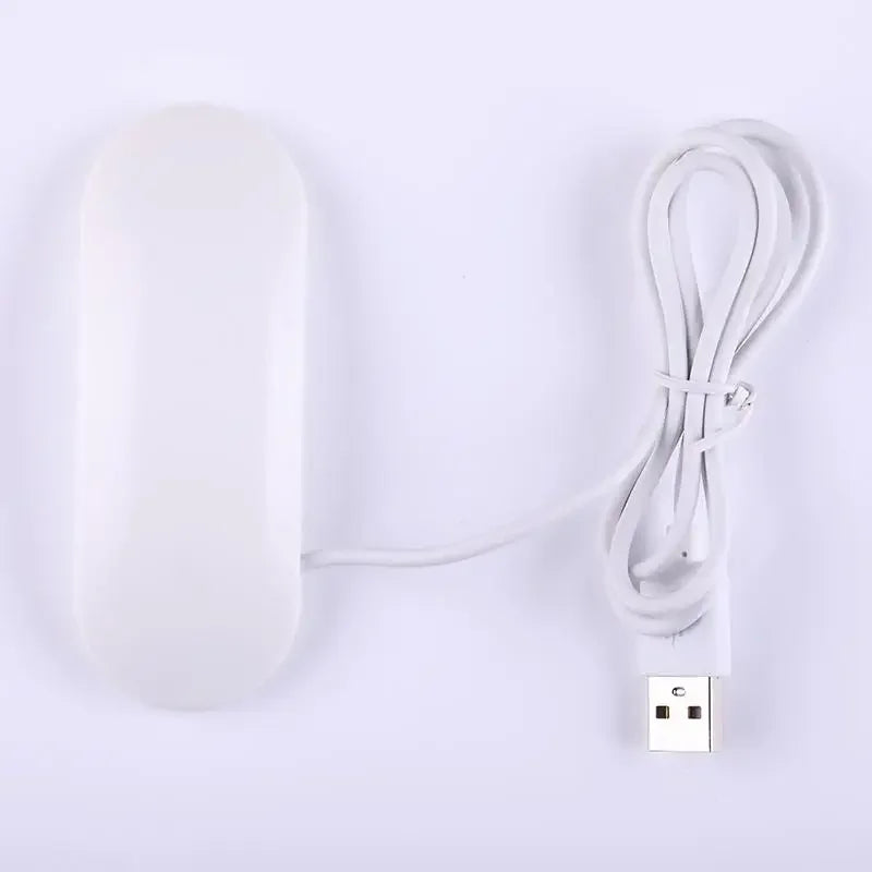Currant UV lamp in white with a USB cable, designed for portable use and compact storage.