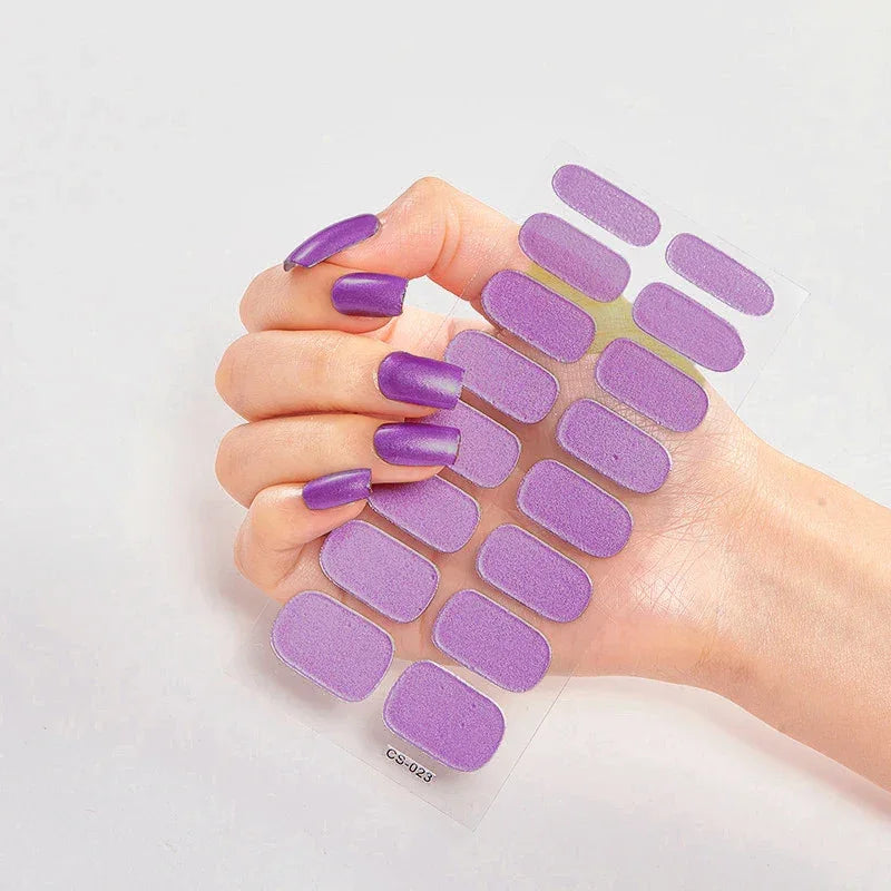 Currant™ nail wraps in long purple designs displayed on a hand against a light background.