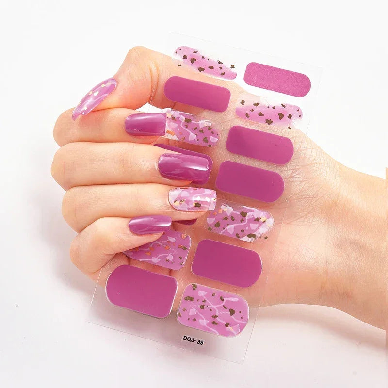 Currant™ nail wraps featuring purple shades and patterns, displayed alongside a hand with manicured nails.