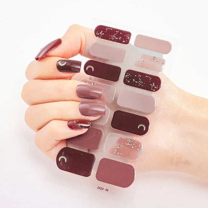 Currant™ nail wraps in burgundy and mauve shades displayed on a hand with long, manicured nails.