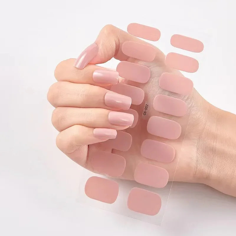 Currant™ nail wraps with a hand showcasing light pink press-on nails and a sheet of matching nail strips.