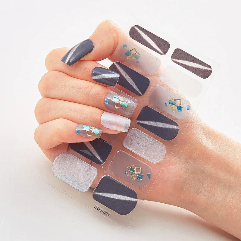 Currant™ Marble nail wraps featuring dark blue, silver, and geometric designs on a hand holding the product sheet.