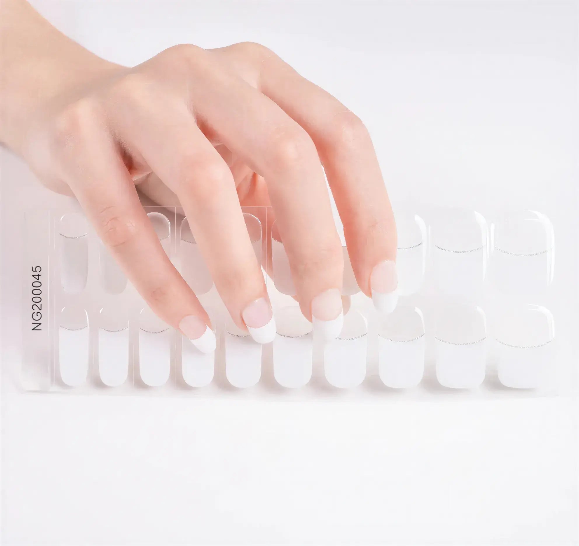 White French-glitter line nail wraps displayed beside a hand with manicured French tip nails on a light background.