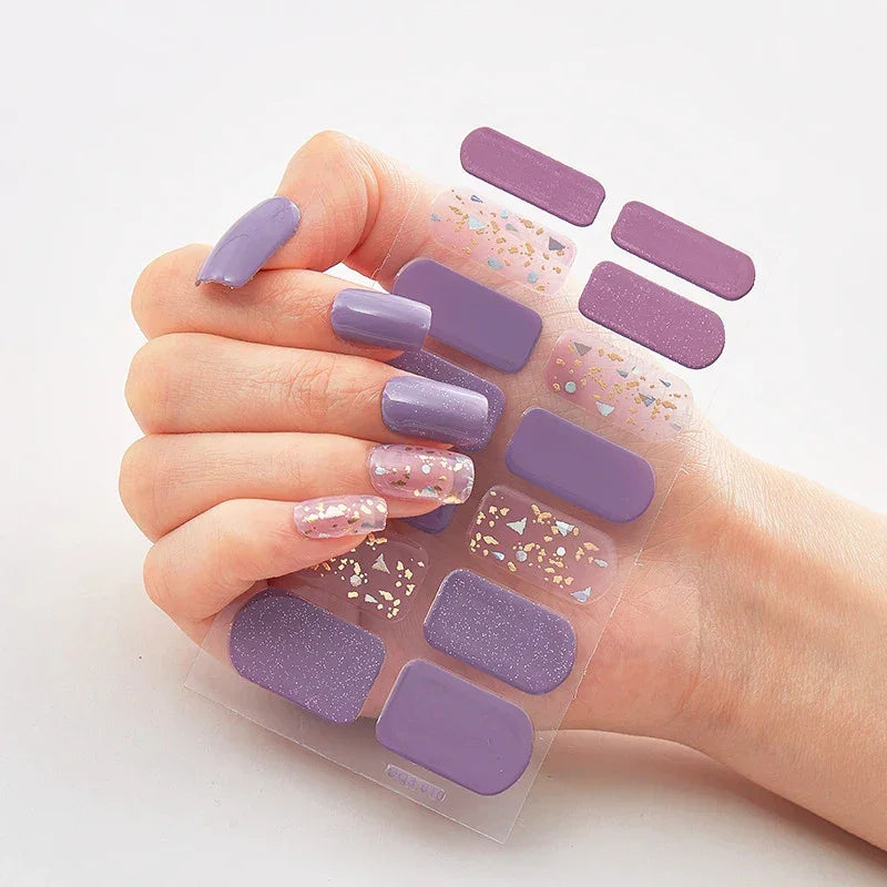 Currant™ Marble nail wraps featuring various shades of purple and glitter, applied to a hand with manicured nails.