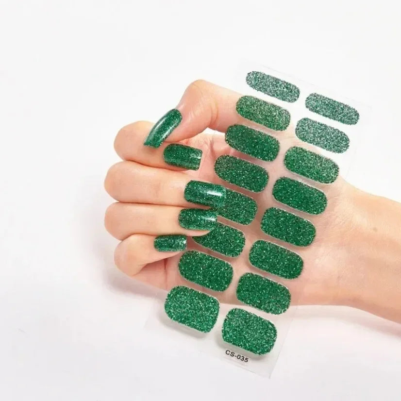 Currant™ Star green glitter nail wraps displayed on a hand with manicured nails.