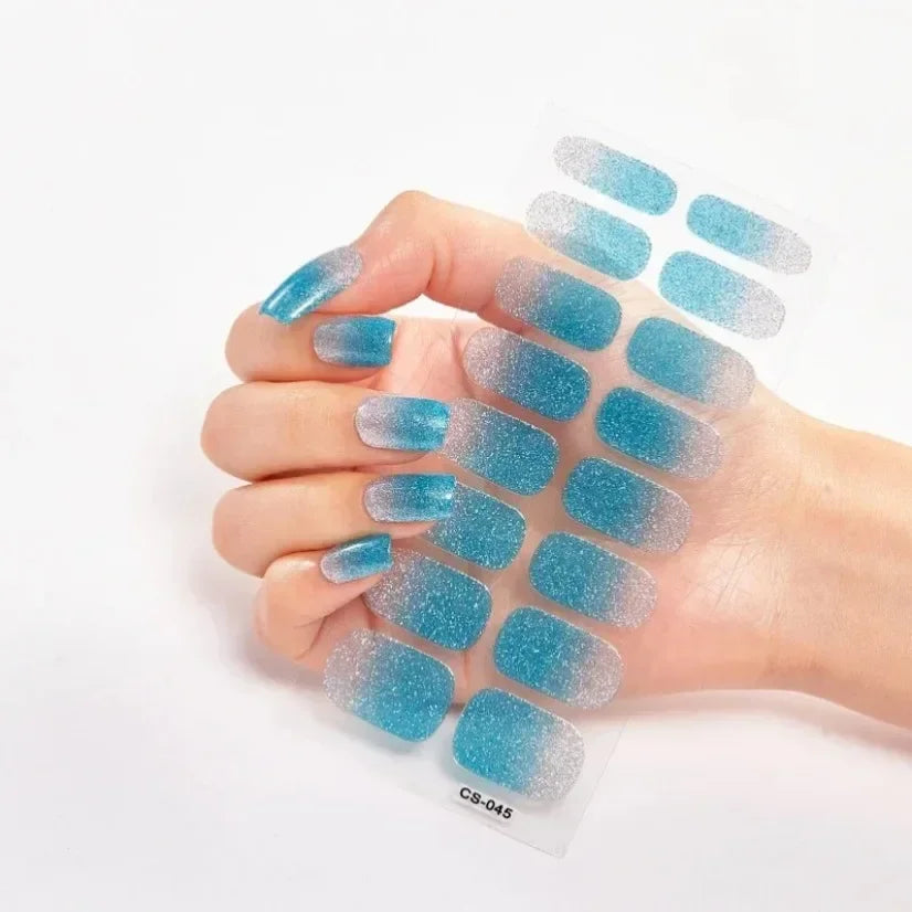 Currant™ Fade nail wraps featuring a gradient from silver to turquoise on a hand with manicured nails.