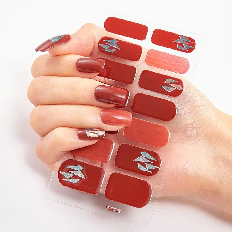 Currant™ Marble nail wraps featuring various shades of red and silver geometric designs on a clear backing.