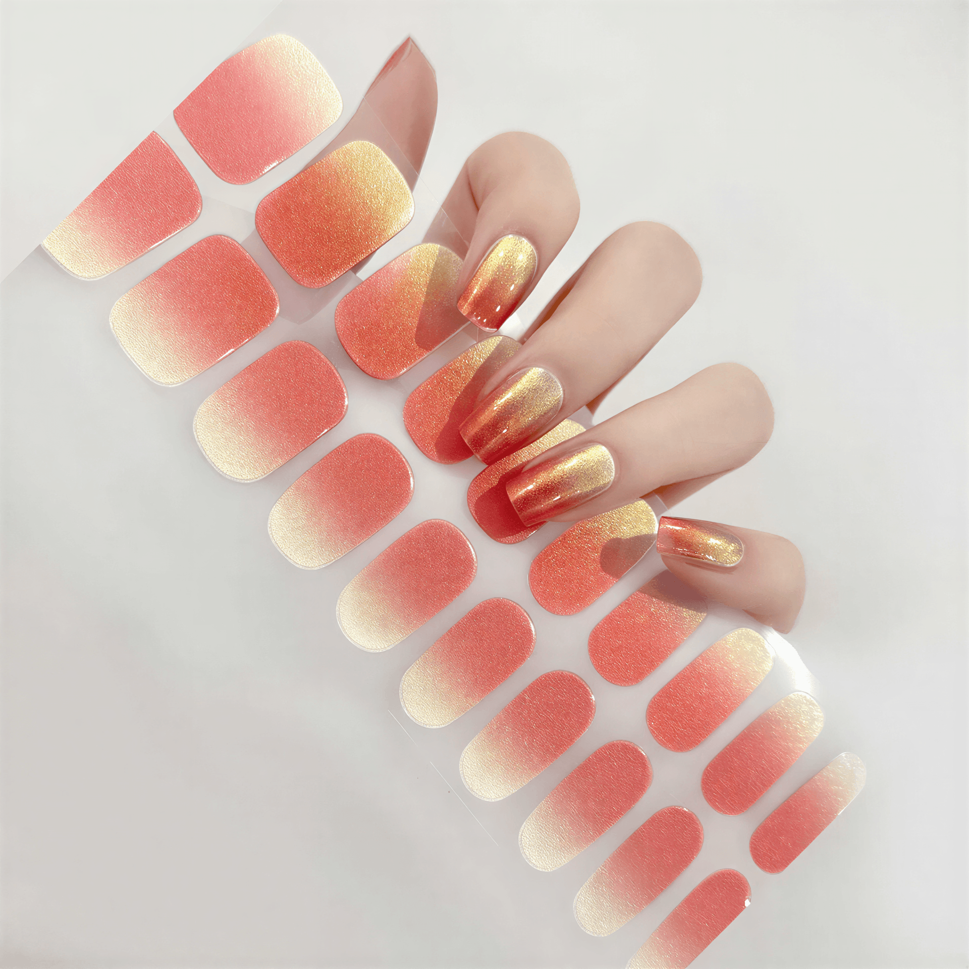 Currant™ Starter Kit featuring sunset gradient nail wraps in orange and gold alongside long, manicured nails.