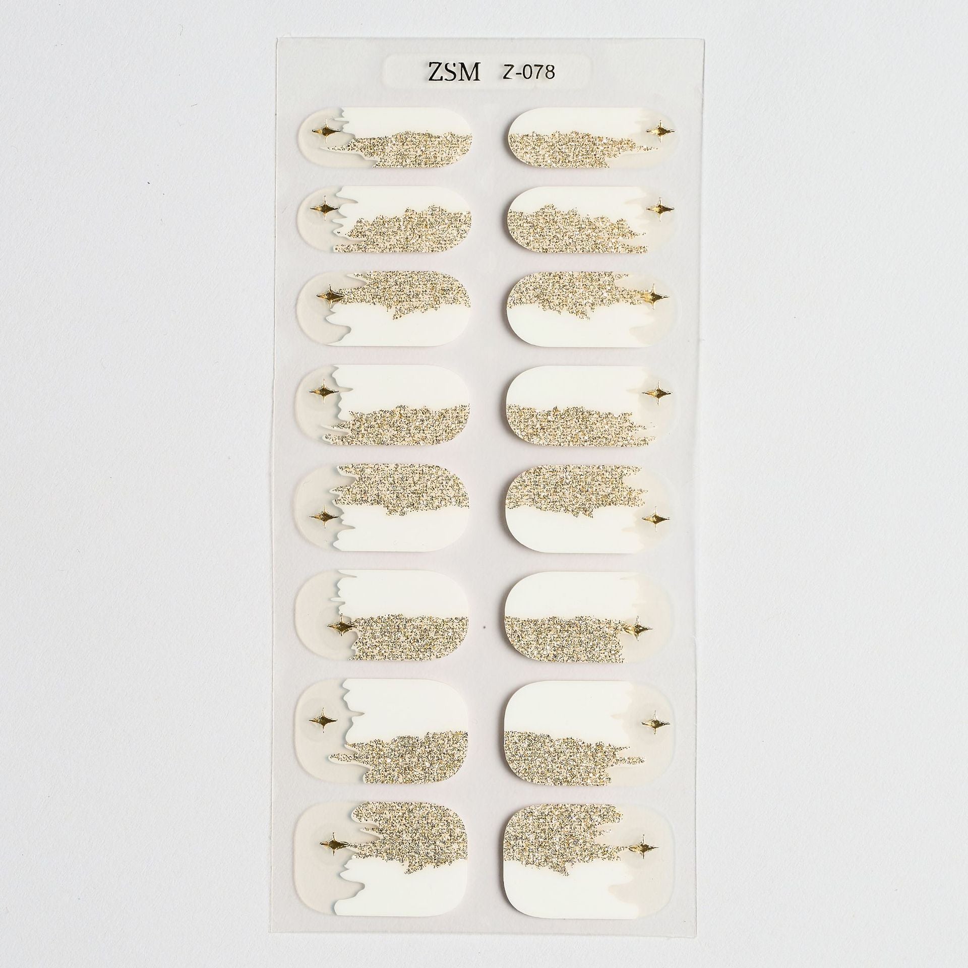 3D nail sticker sheet featuring white and gold designs with glitter accents on a clear backing.
