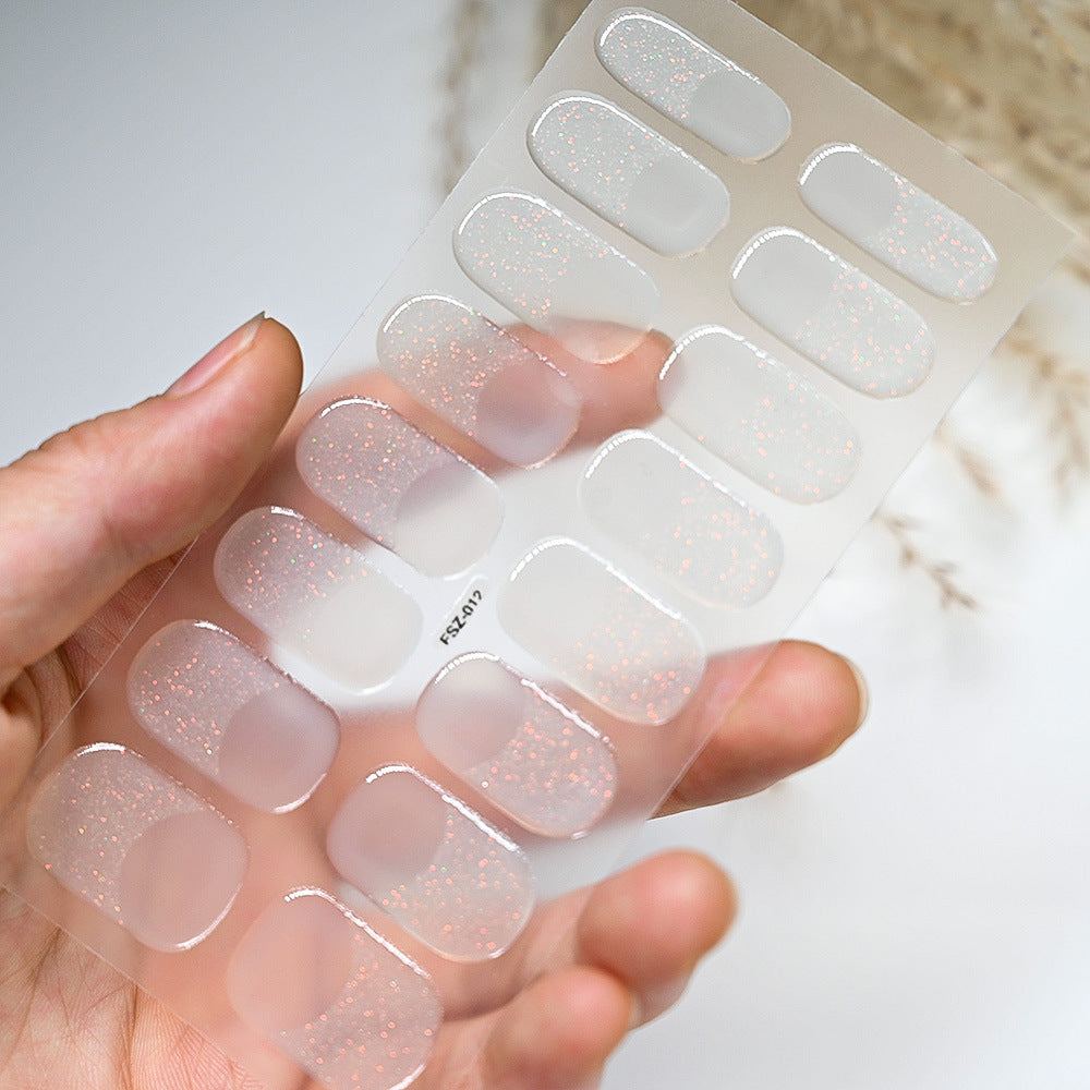 French glitter nail strips in a clear package, showcasing a gradient of pink and silver glitter.
