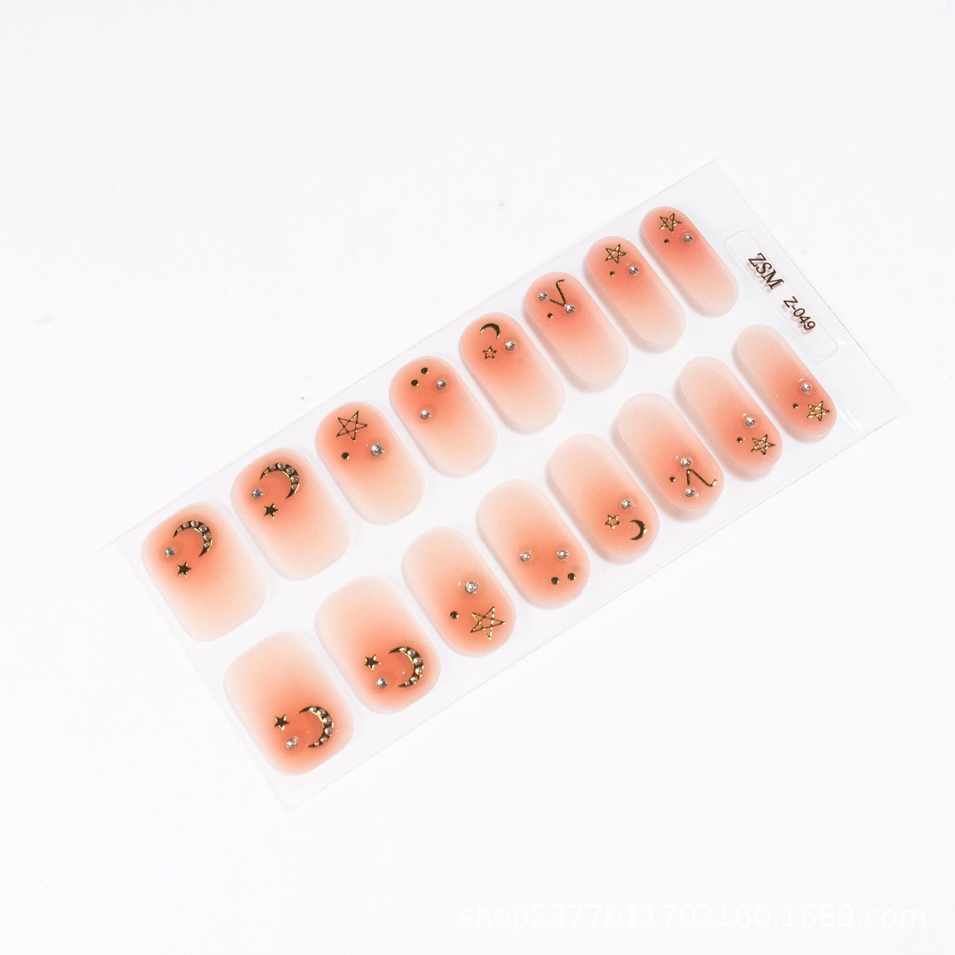 3D nail sticker set featuring peach-colored nails with gold star and moon designs on a clear backing.