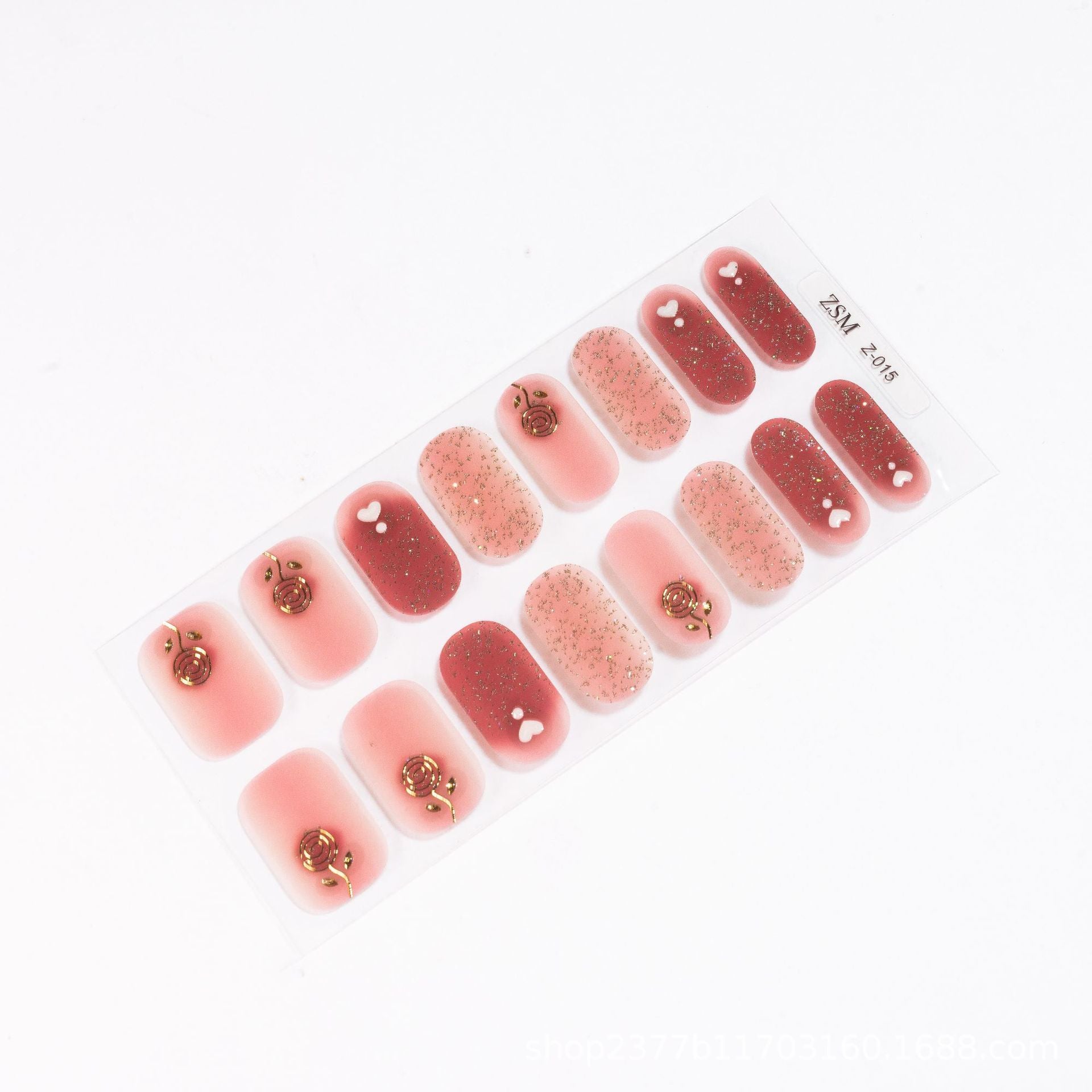 3D nail stickers featuring pink and red designs with gold accents and glitter on a clear backing sheet.